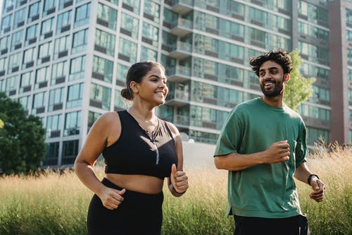 Healthy young couple going outdoors for a jog