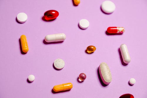 Prescription drugs spilt over a purple canvas