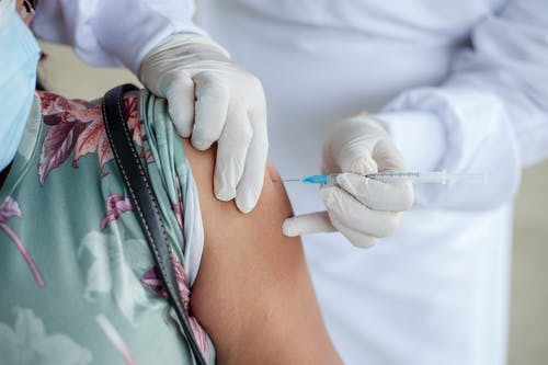 female getting vaccinated in bicep