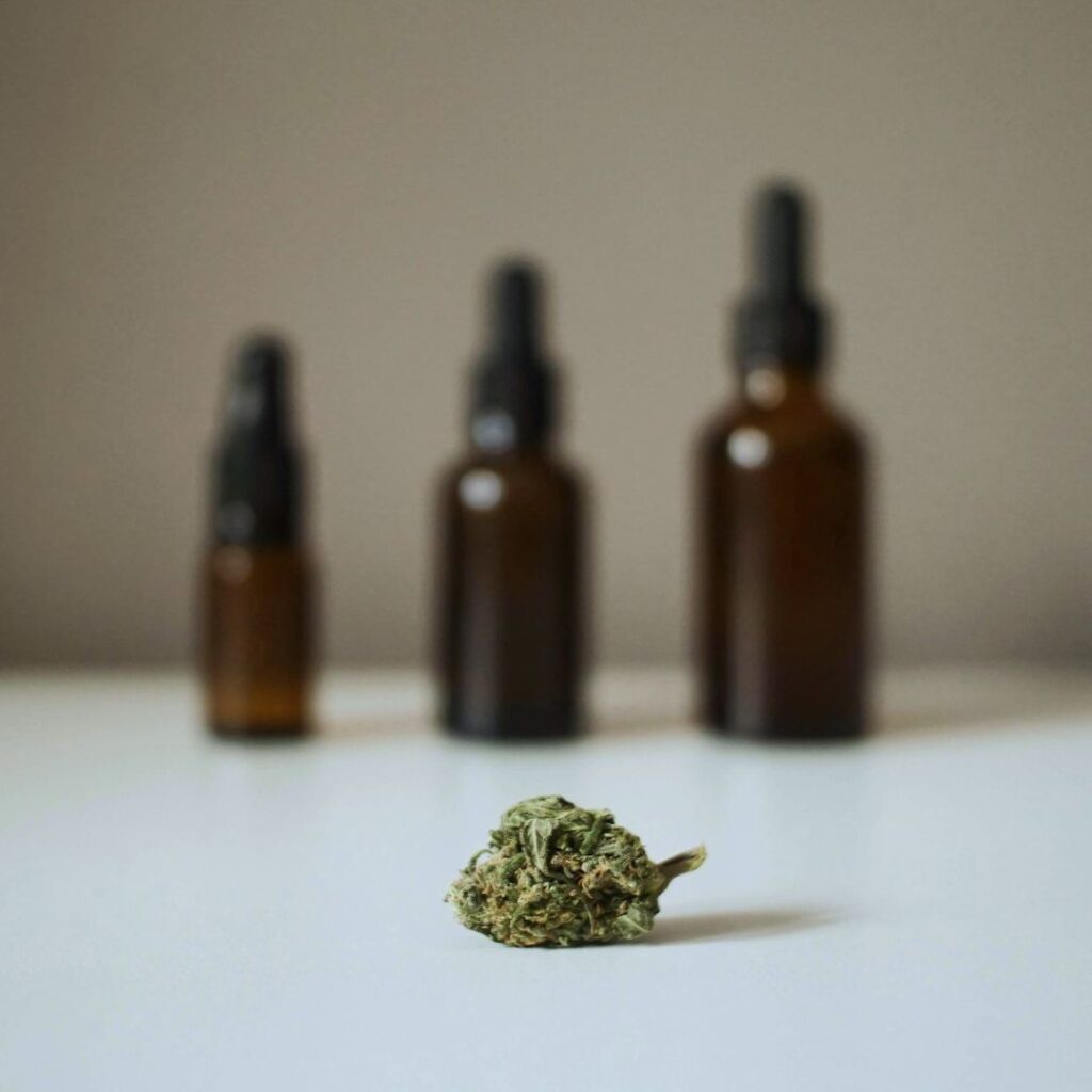 small image of a medical cannabis bud in front of medical cannabis oils