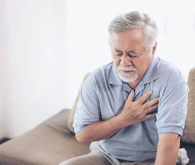 an older man in distress because of heartburn seeking treatment from a pharmacist