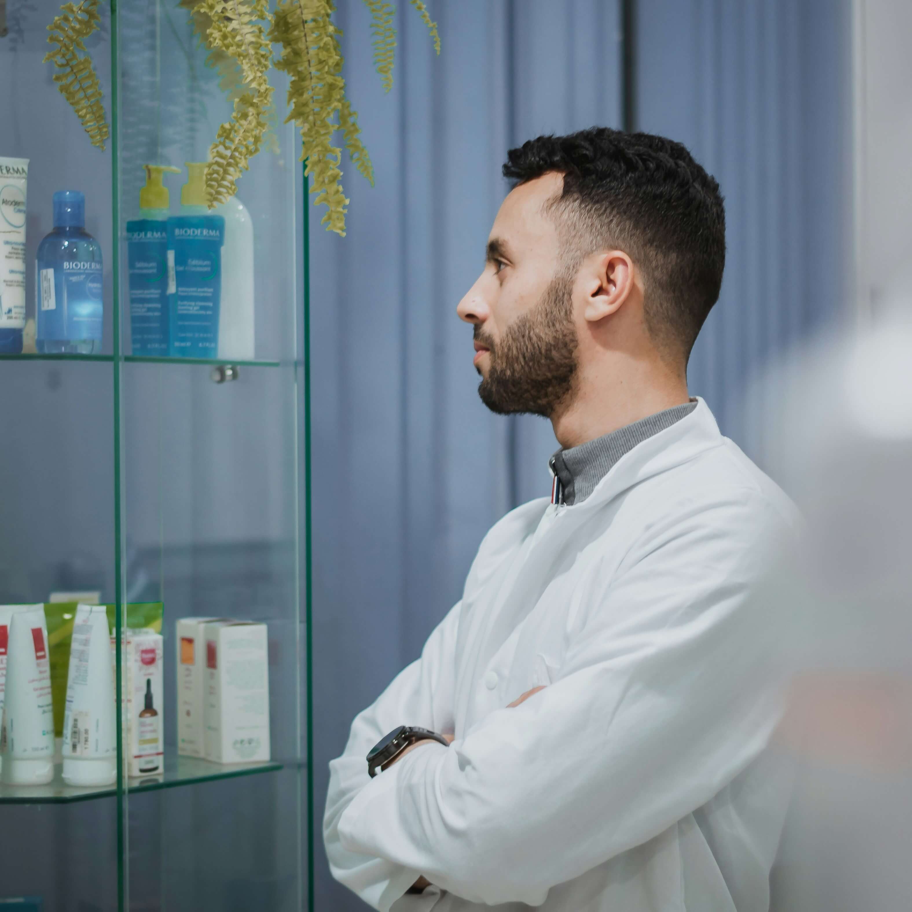 Ottawa an Orleans Pharmacist reviewing medications on a pharmacy shelf, representing Ontario's minor ailment prescribing services for UTIs, strep throat, ear infections, and more.