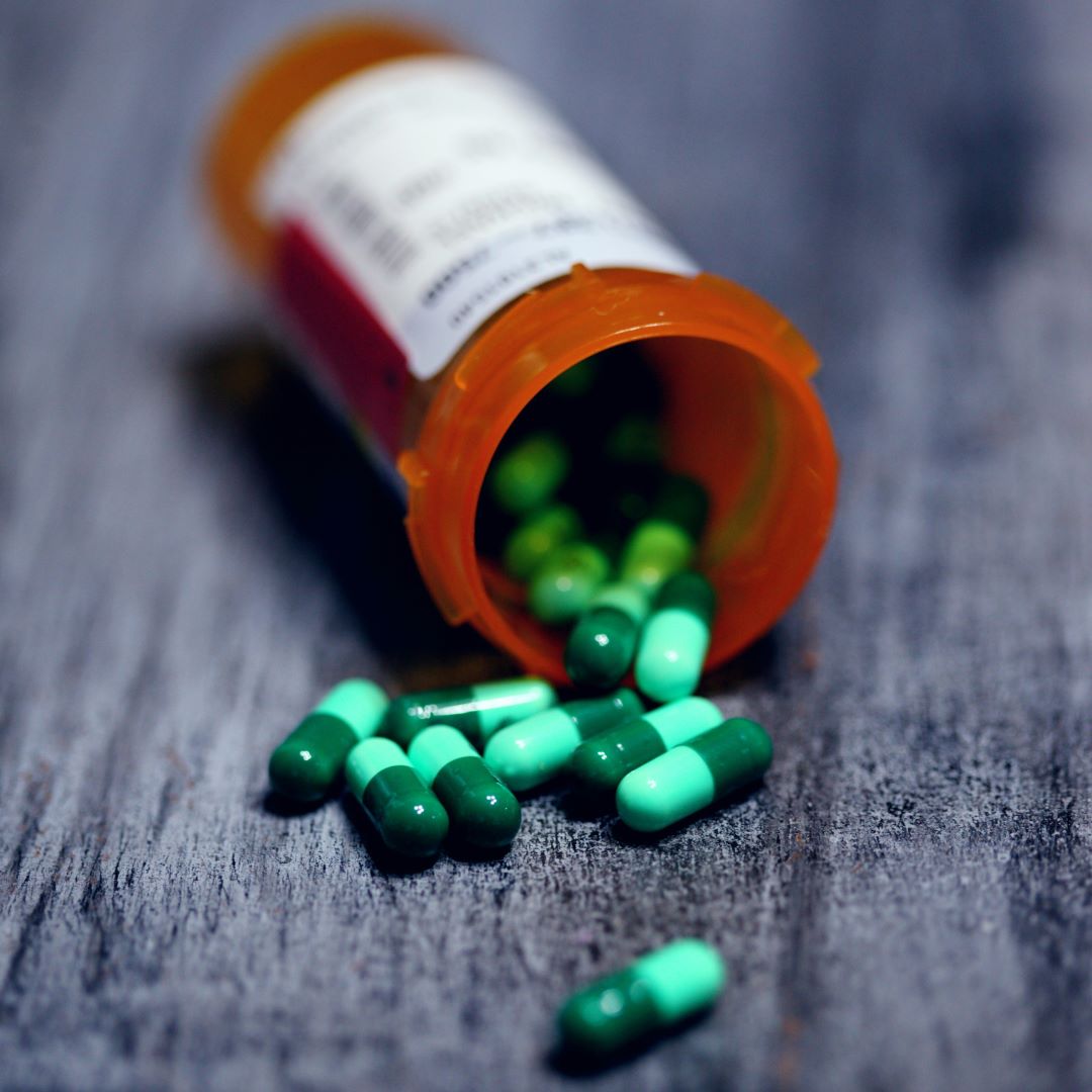 Pills spilling out of a prescription bottle, symbolizing prescription extension services available in Ottawa and Orleans.
