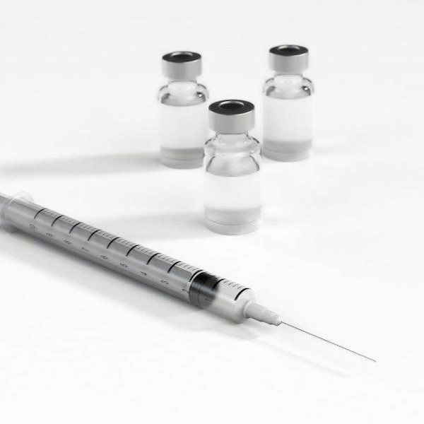 photo of vaccinations prepared by a pharmacist and a needle