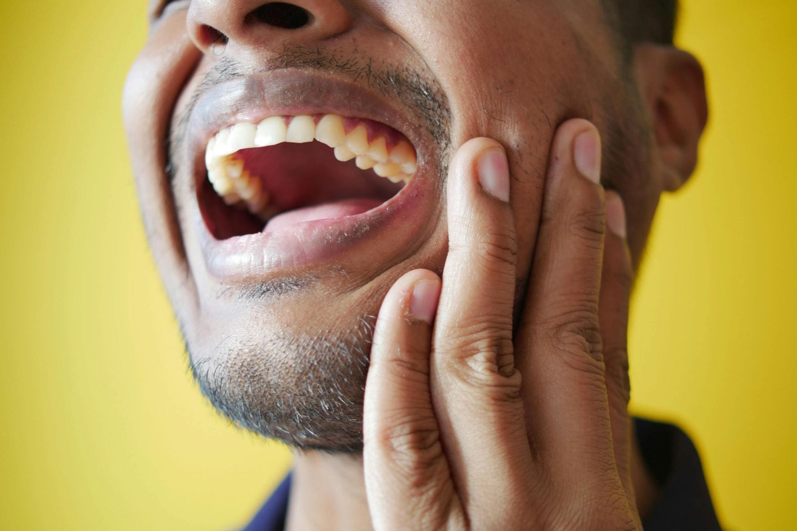 a photo of a man in distress from a canker sore seeks help from an Ottawa or Orleans pharmacist