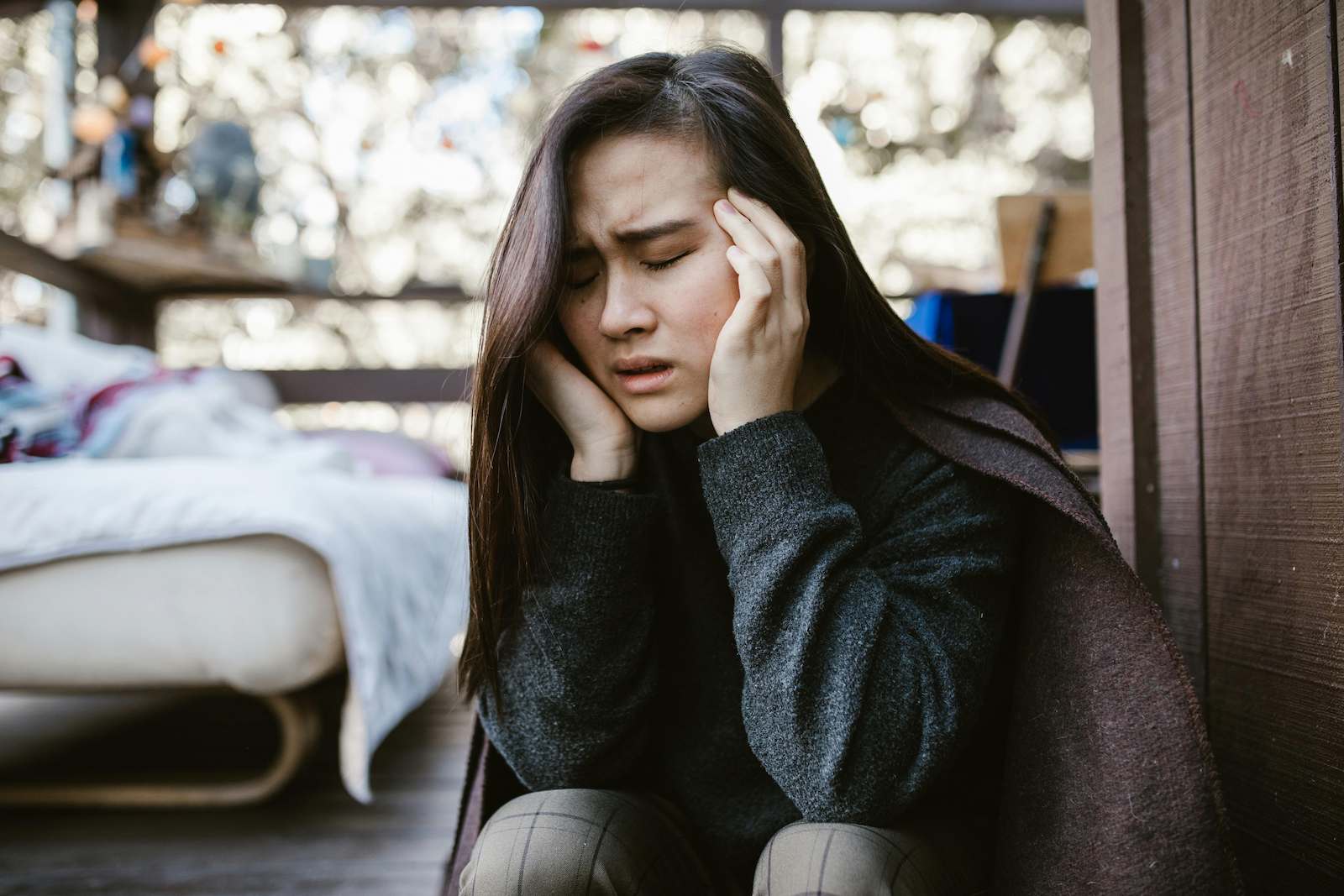 A woman in Orleans, Ottawa suffering from a minor headache, treatable by a Centrum Pharmacist.