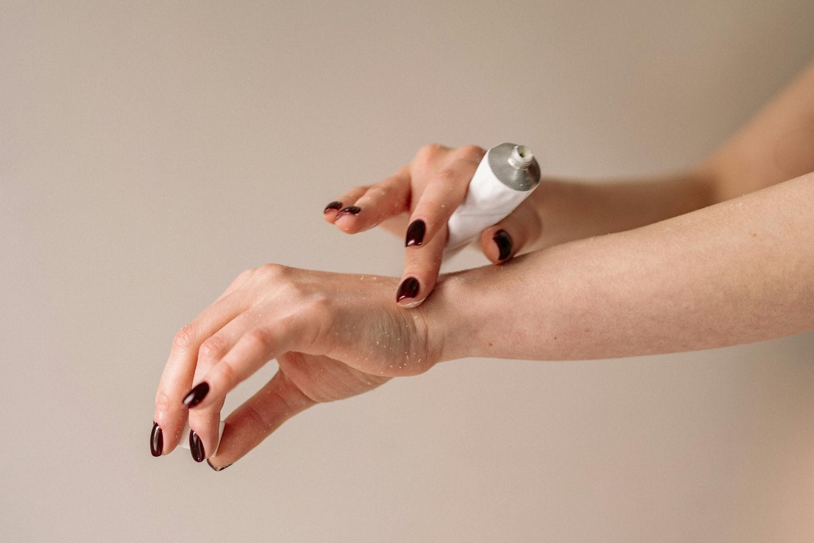 Orleans woman applying cream from a pharmacist to her hand to treat ringworm.